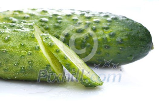 green cucumber with water drops isolated on white