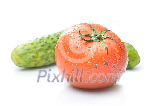 red tomato and green cucumber with water drops isolated on white