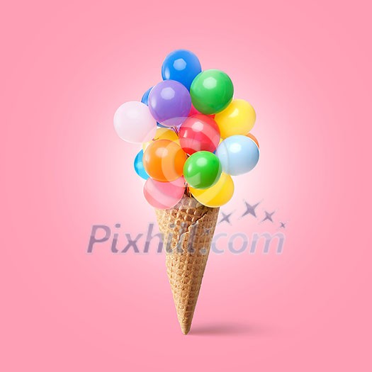 Waffle cornet with balloons isolated on pink Waffle cornet with balloons isolated on pink