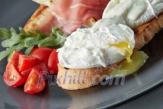 Eggs Benedict on toasted muffins with ham and sauce Eggs Benedict on toasted muffins with ham and sauce