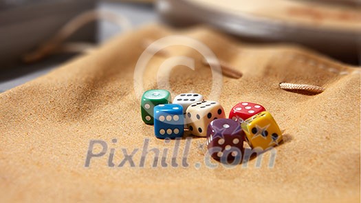 multicolored game dice for gambling, isolated on a brown background multicolored game dice for gambling, isolated on a brown background