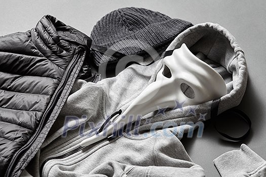 winter warm jacket and sweater on a gray background winter warm jacket and sweater on a gray background