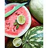 Background of fresh ripe watermelon slices with knife, slice lime and mint