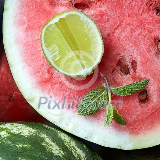 Close-up of fresh slices of red watermelon with slice lime and mint Close-up of fresh slices of red watermelon with slice lime and mint