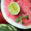 Close-up of fresh slices of red watermelon with slice lime and mint