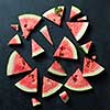 slices of watermelon with mint isolated on black background