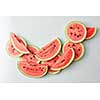 many slices of watermelon on a light background