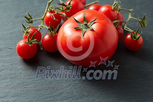 Cherry red tomatoes on Black Stone Surface