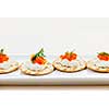 Caviar appetizer with goat cheese and crackers on white plate