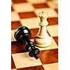 Closeup of checkmate on king by queen winning in chess game