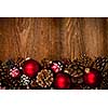 Rustic wood background with Christmas ornaments and pine cones