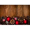 Rustic wood background with Christmas ornaments and pine cones