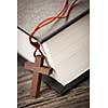 Closeup of wooden Christian cross necklace next to holy Bible