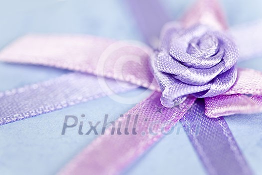 Closeup of pink gift ribbon and bow on present Closeup of pink gift ribbon and bow on present