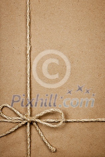 Brown paper gift package background with twine and copy space