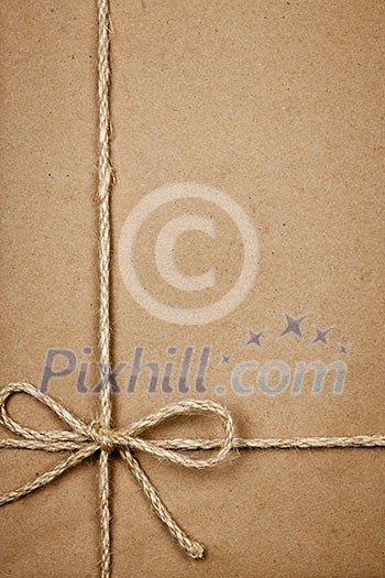 Brown paper gift package background with twine and copy space Brown paper gift package background with twine and copy space