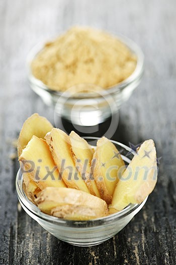 Sliced and ground fresh ginger root spice in glass bowls Sliced and ground fresh ginger root spice in glass bowls