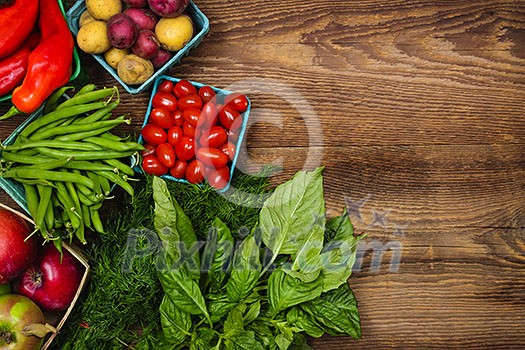 Fresh farmers market fruit and vegetable from above with copy space on brown wood