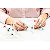 Hand of female student assembling amino acid molecule models for science project