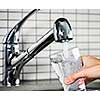 Filling glass of water from stainless steel kitchen faucet