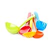 Various colorful plastic kitchen utensils on white background