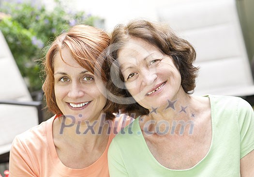 Family portrait of smiling mature mother and daughter