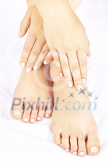 Soft female feet and hands with pedicure and manicure