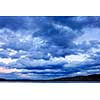 Blue cloudy dramatic sky at sunset over forest wilderness in Algonquin Park, Canada