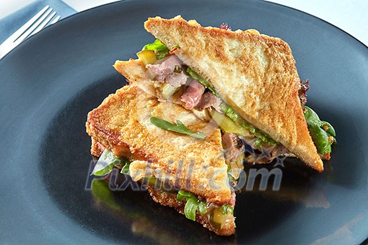 Healthy sandwich with bacon, arugula for breakfast on black plate Healthy sandwich with bacon, arugula for breakfast on black plate
