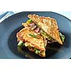 Healthy sandwich with bacon, arugula for breakfast on black plate