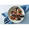 Mussel with white wine sauce on a light background