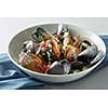 dish of mussels pics with tomato sauce, open, ready to eat on a light background