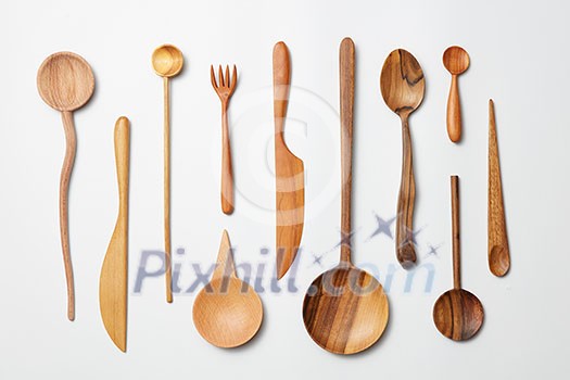 Wooden spoons, knives, forks on a white background Wooden spoons, knives, forks on a white background