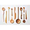 Wooden spoons, knives, forks on a white background