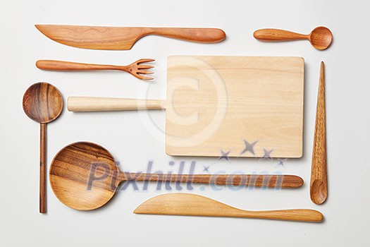 Wooden kitchen utensils on white background. Cutting board, fork, knife and spoon Wooden kitchen utensils on white background. Cutting board, fork, knife and spoon