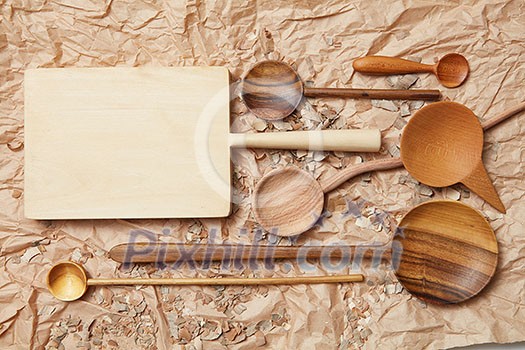 wooden kitchen utensil on baking paper background wooden kitchen utensil on baking paper background