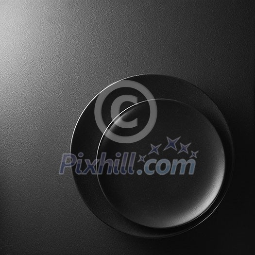 Black plates on a textured black background. Black plates on a textured black background.