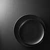 Black plates on a textured black background.