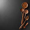 Wood spoons on black board background. Space for text