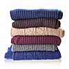 Pile of knitted winter clothes isolated on white, sweaters, knitwear,