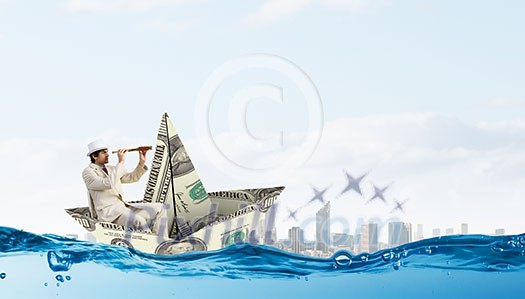 Successful businessman sailing on dollar boat in financial sea