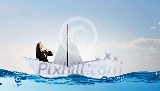Successful businesswoman sailing on paper boat in financial sea Successful businesswoman sailing on paper boat in financial sea