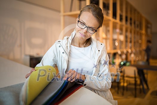Pretty young woman choosing the right material/color for her modern appartement interior (shallow DOF; color toned image) Pretty young woman choosing the right material/color for her modern appartement interior (shallow DOF; color toned image)