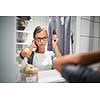 Young woman brushing healthy hair in front of a mirror morning before leaving for work (color toned image; shallow DOF)