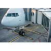 Aircraft with passage corridor/tunnel being prepared for departure from an international airport - Passangers boarding an airplane in a modern airport