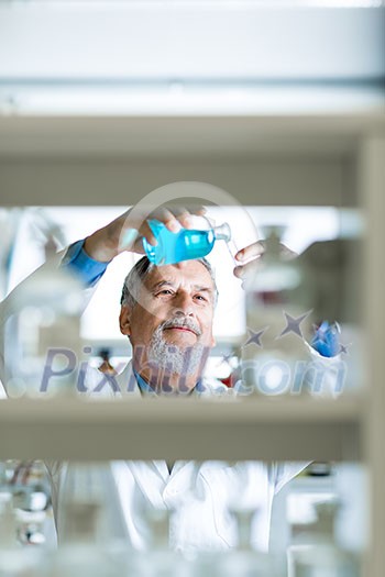 Senior male researcher carrying out scientific research in a lab (shallow DOF; color toned image) Senior male researcher carrying out scientific research in a lab (shallow DOF; color toned image)