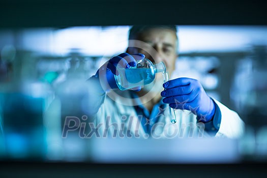 Senior male researcher carrying out scientific research in a lab (shallow DOF; color toned image) Senior male researcher carrying out scientific research in a lab (shallow DOF; color toned image)