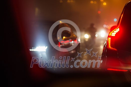 Evening/Night City car traffic - cars on a city road polluting city air with exhaust fumes containing many agents harmful for human health Evening/Night City car traffic - cars on a city road polluting city air with exhaust fumes containing many agents harmful for human health