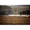 Tractor plowing a dry farm field