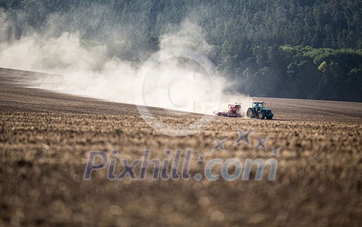 Tractor plowing a dry farm field Tractor plowing a dry farm field